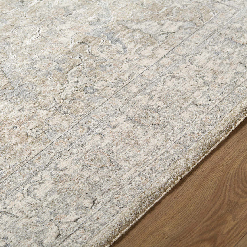 Close-up of the Brynja Cream Area Rug showing its farmhouse style pattern and soft texture on hardwood floor. Texture