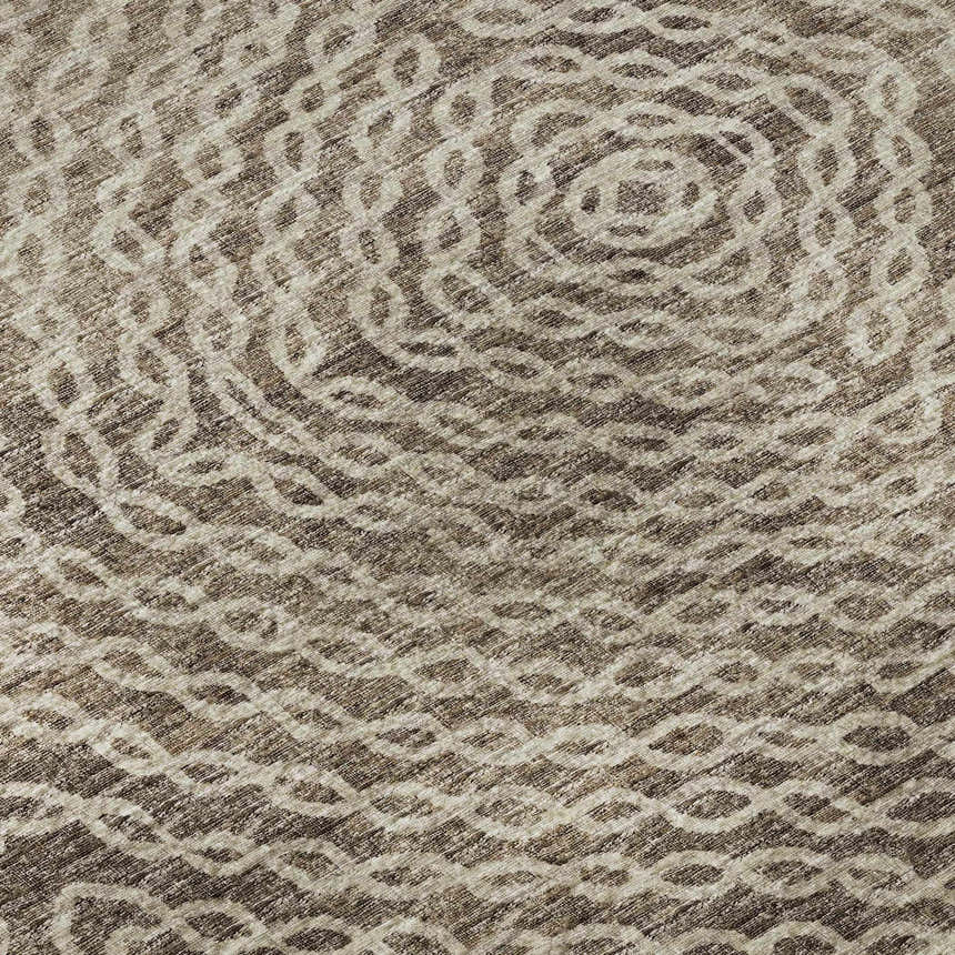 Close-up of the Dalyn Brisbane BR3 Mink Washable Area Rug, featuring a beige and brown circular pattern.