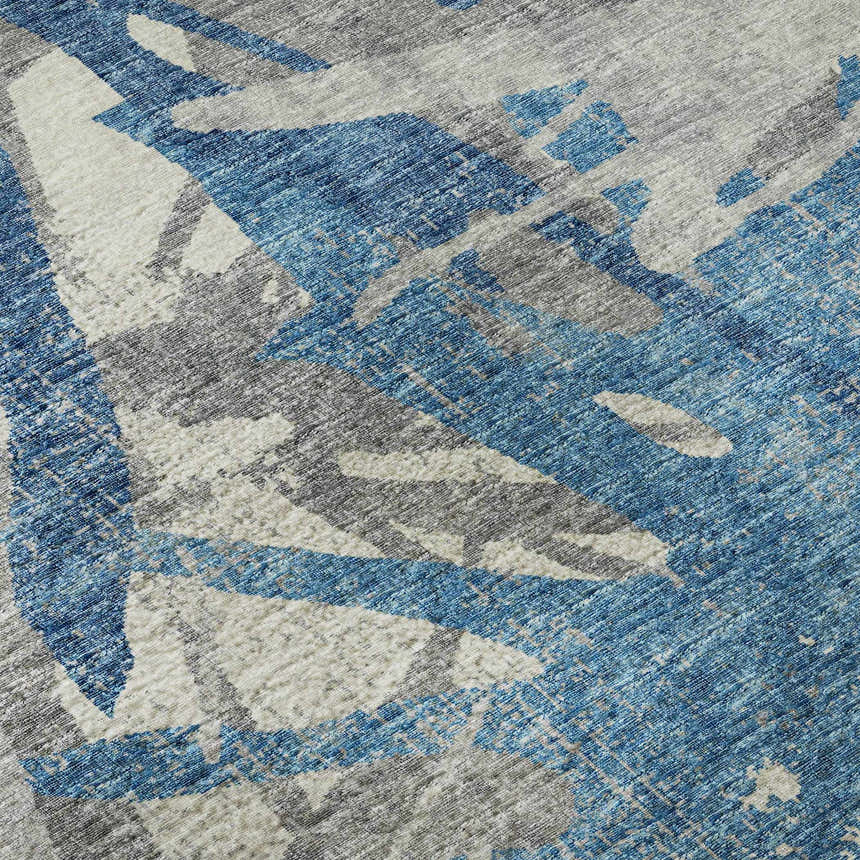Close-up of Dalyn Brisbane BR6 Cobalt Washable Area Rug. Features a casual abstract pattern in blue, navy, taupe, and gray.