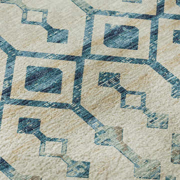Close-up of Dalyn Brisbane BR8 Linen Washable Area Rug. Beige rug with geometric teal and ivory pattern.