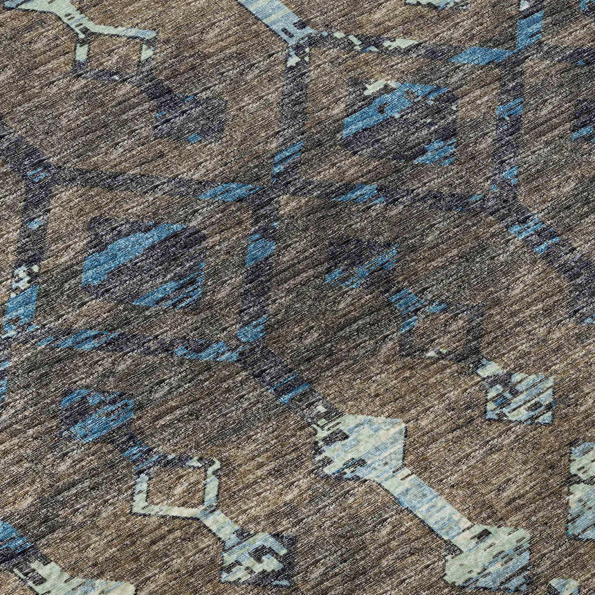Close-up of the Dalyn Brisbane BR8 Sable Washable Area Rug. Features brown, light blue, navy, sable, and taupe tones.
