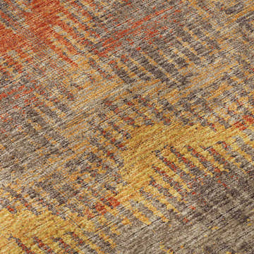 Close-up of Dalyn Brisbane BR9 Sunset Washable Area Rug. Abstract design in brown, gold, sunset, and taupe hues.