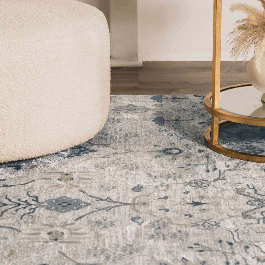 Close-up of the Barkisland Thick Luxe Oushak Rug in light beige, teal, and gray with a floral pattern and a textured weave. Styleshot