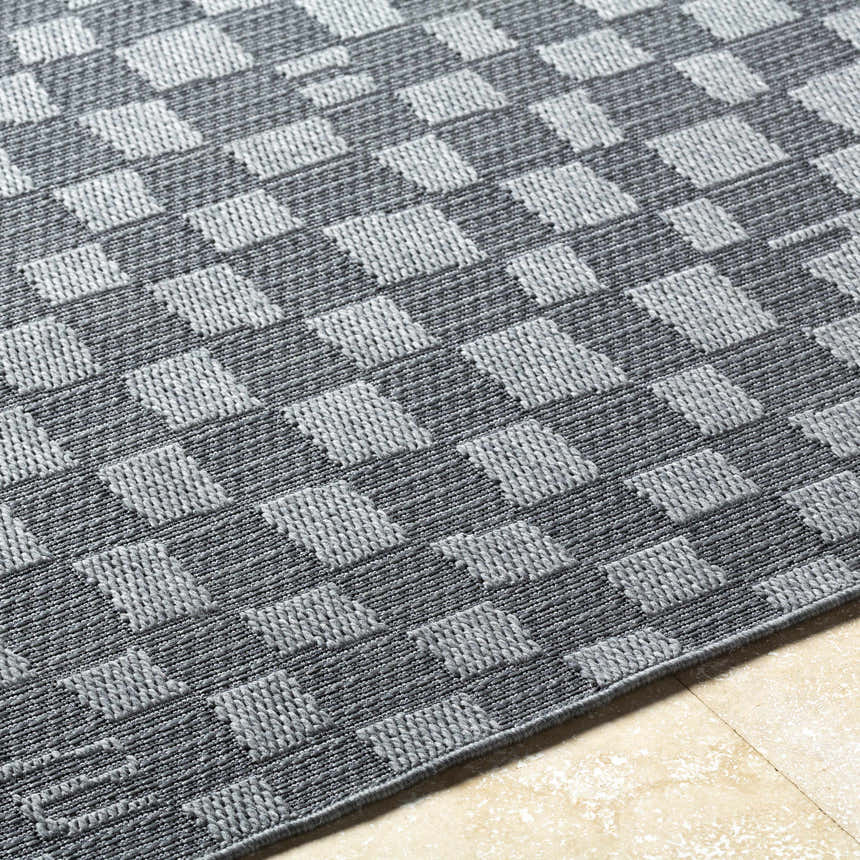 Close up of the Arifah Gray Area Rug showing a woven gray and light gray geometric checkerboard pattern. Texture