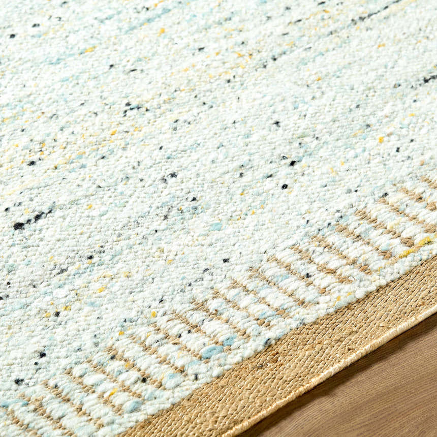 Close-up of the hand-woven Andrey Dark Beige Area Rug. Features charcoal, light & medium brown tones, and a textured wool design. Texture