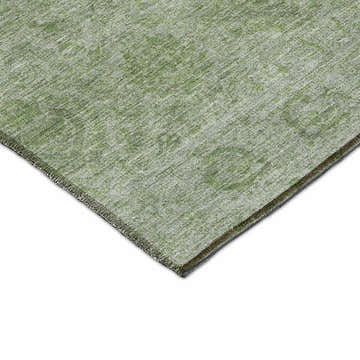 Close-up of the Dalyn Luxury Burano BU8 Olive Washable Area Rug. Green, aloe, and silver gray tones with a subtle pattern.