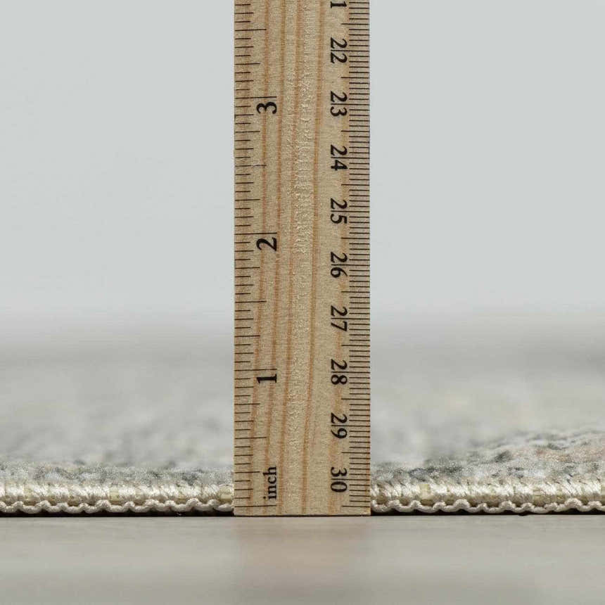 Close-up of the pile height of the Collins Avenue I Vintage Oushak Area Rug with a ruler. Pile