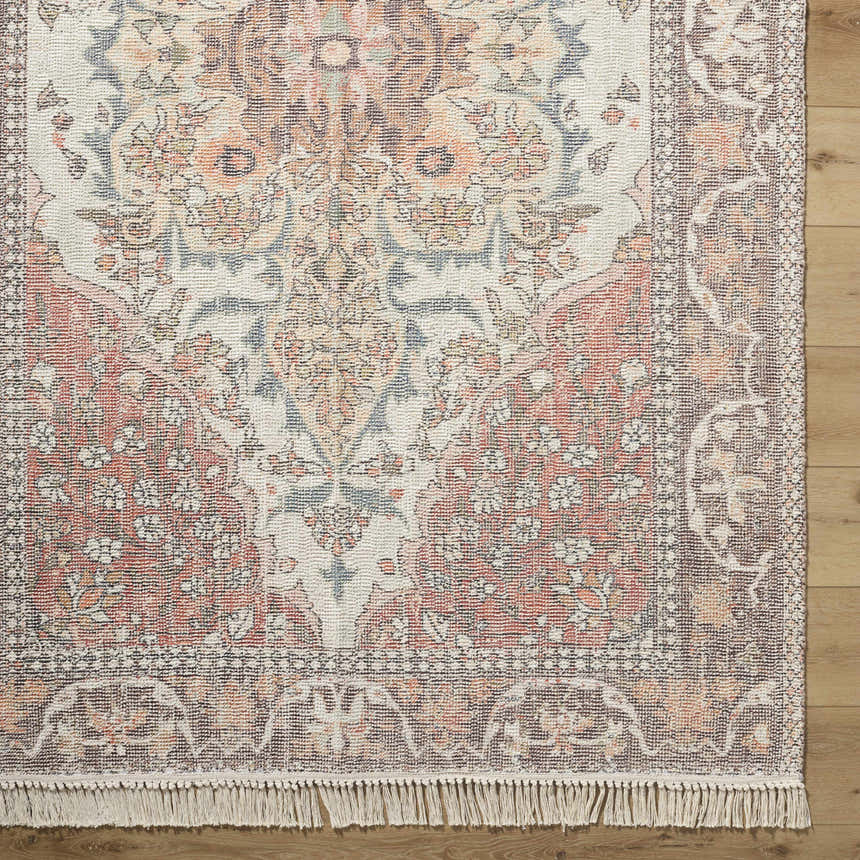 Close-up of the hand-loomed Bohdan Terracotta Area Rug. Features charcoal, ivory, slate blue, taupe, and terracotta colors. Corner