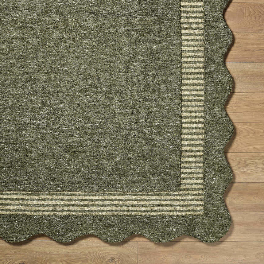 Close-up of Wone Green Border Hand Tufted Wool Area Rug showing texture, striped border, and scalloped edge. Corner