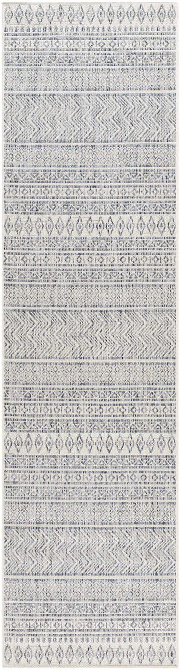 Close-up of the Madras Navy All Over Performance Rug. Features a bohemian-inspired geometric pattern in navy, gray, and off-white. Design-Runner-2710