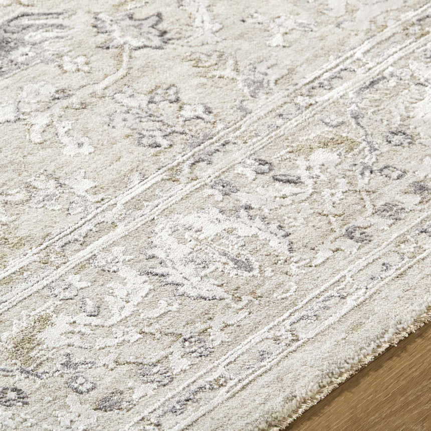Close-up of the Corina Charcoal Area Rug showing its floral pattern, texture, and charcoal, cream, and ivory colors. Texture