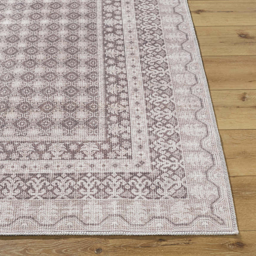Close-up of the Rainier Light Brown Washable Rug showing the traditional, geometric pattern and light brown, cream colors. Front