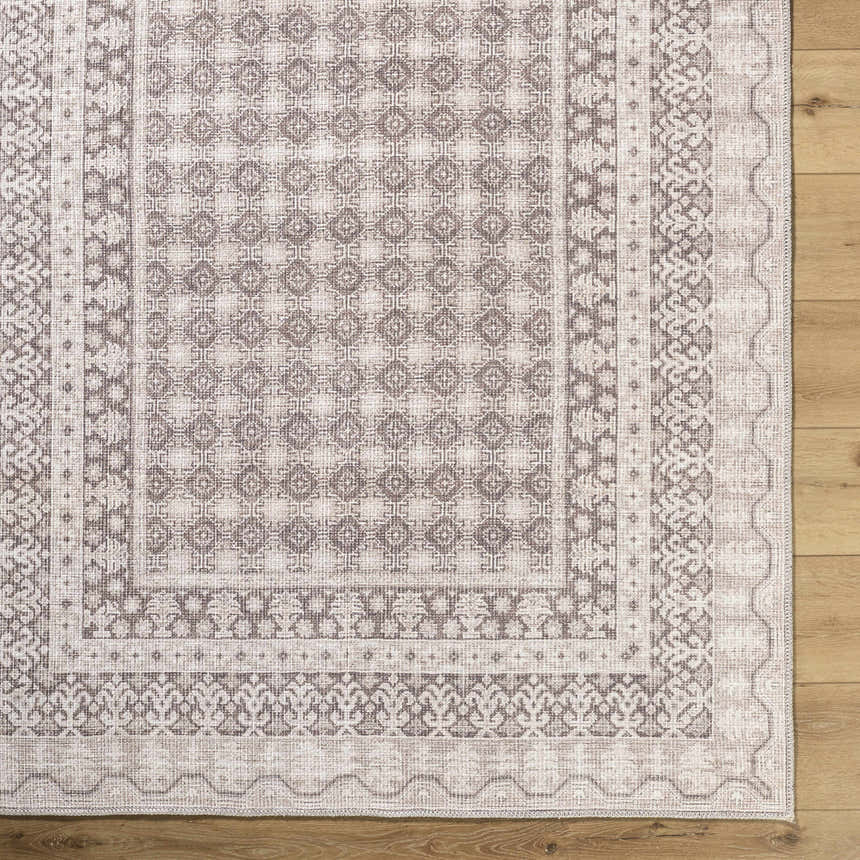 Close-up of Rainier Light Brown Washable Rug. Farmhouse style rug with cream, dark brown, and light brown traditional pattern. Swatch