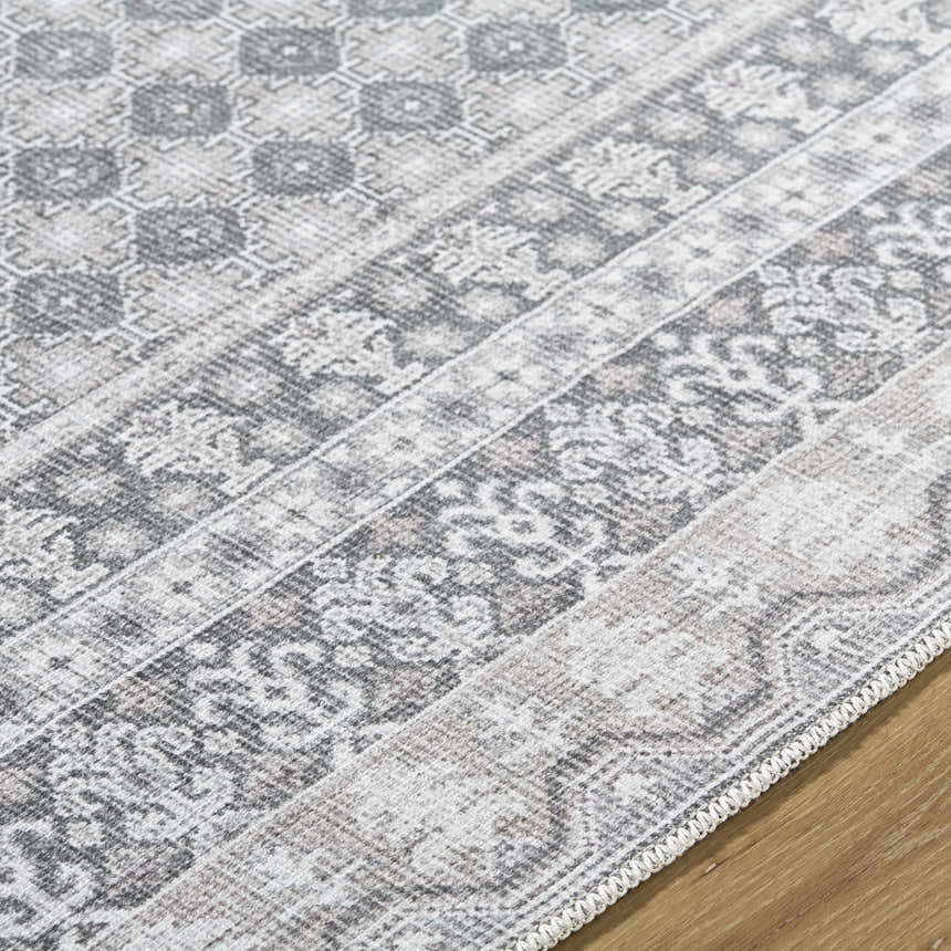 Close-up of the Rainier PNW Home x LIVABLISS rug. Features farmhouse-style, off-white, pale blue, sage, and tan colors. Texture