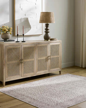 Living room scene with Spokane Machine Woven rug in burnt orange and cream, styled with a wooden cabinet and decor. Roomscene-Rectangle