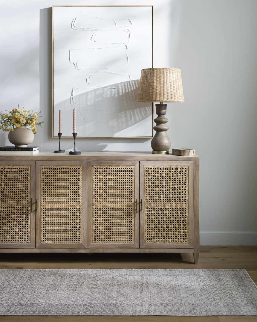 Living room scene with a Spokane Cream Area Rug, wood floors, and a stylish console table. Roomscene-Rectangle