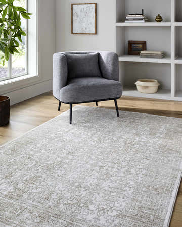 Light-filled living room with gray chair on Beth Machine Woven Vivir x LIVABLISS area rug in cream and sage. Roomscene-Rectangle