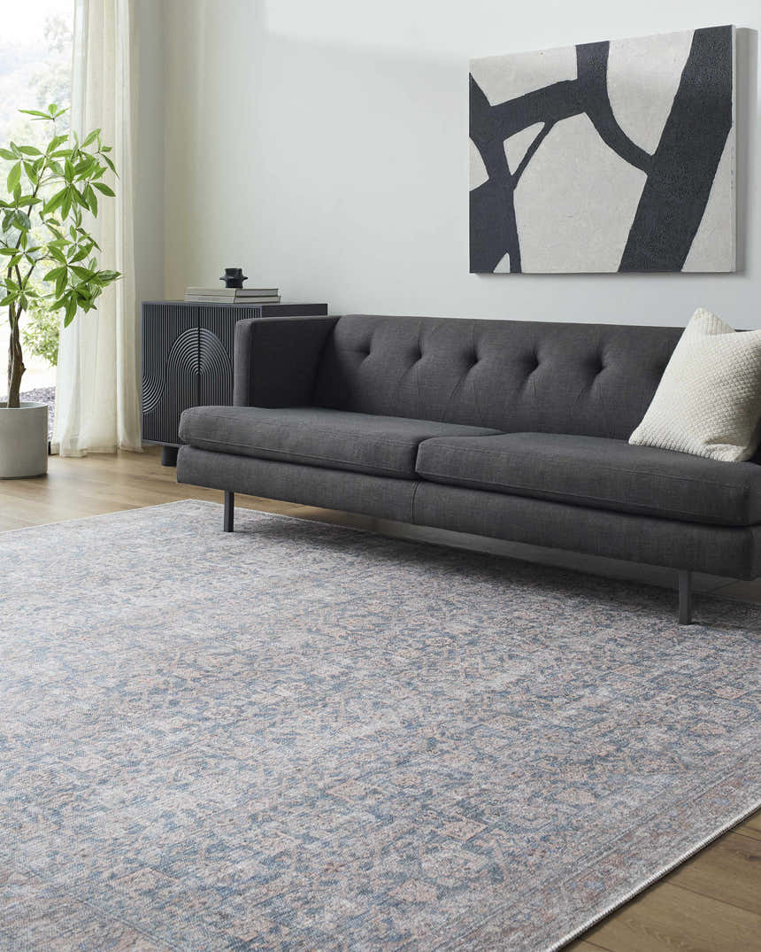 Living room scene with gray sofa and the Lorelai Vivir x LIVABLISS Washable Area Rug in denim, tan, and sage. Roomscene-Rectangle