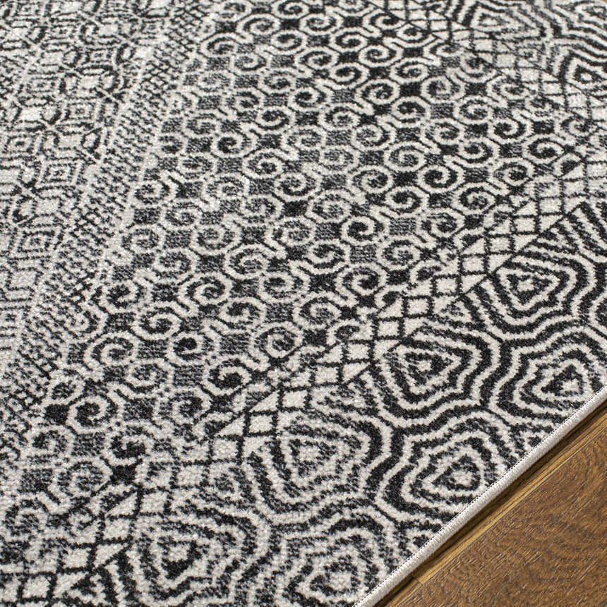 Close-up of Coledale Black & White Washable Rug showing geometric, oriental-inspired patterns and soft texture. Texture