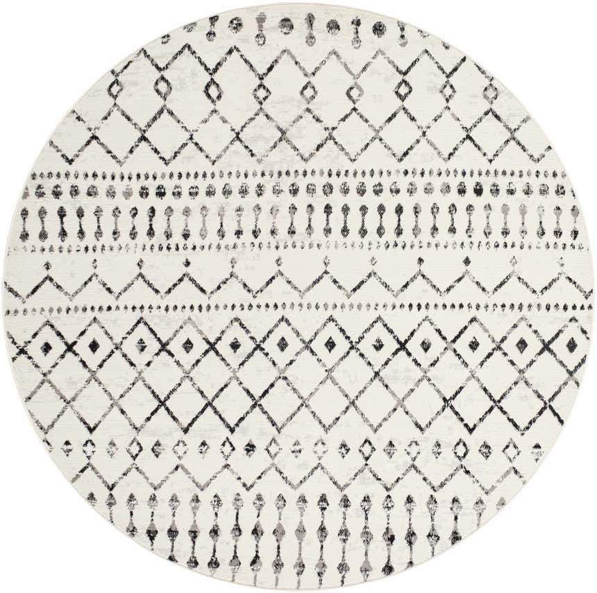 Close-up of a round Scandi Moroccan Trellis Rug. Off-white rug with black and gray diamond and geometric patterns. Design-Round-67