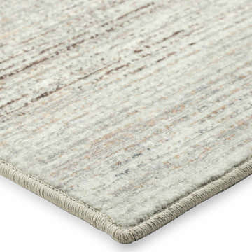 Close-up of Dalyn Ciara CR1 Linen Area Rug. Beige, chestnut, and ivory tones with subtle linear pattern and textured border.