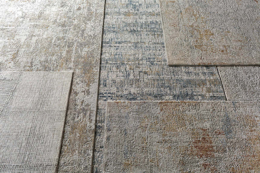 Close-up of the Runa Area Rug, showcasing its contemporary design, blue, brown, and off-white colors, and machine-woven texture. Styleshot