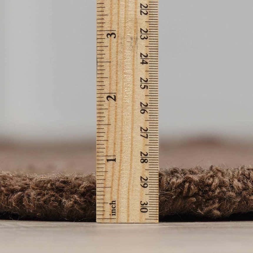 Close-up of the pile height of the hand-tufted Chogan Chocolate Brown Area Rug, made of 100% wool. Pile