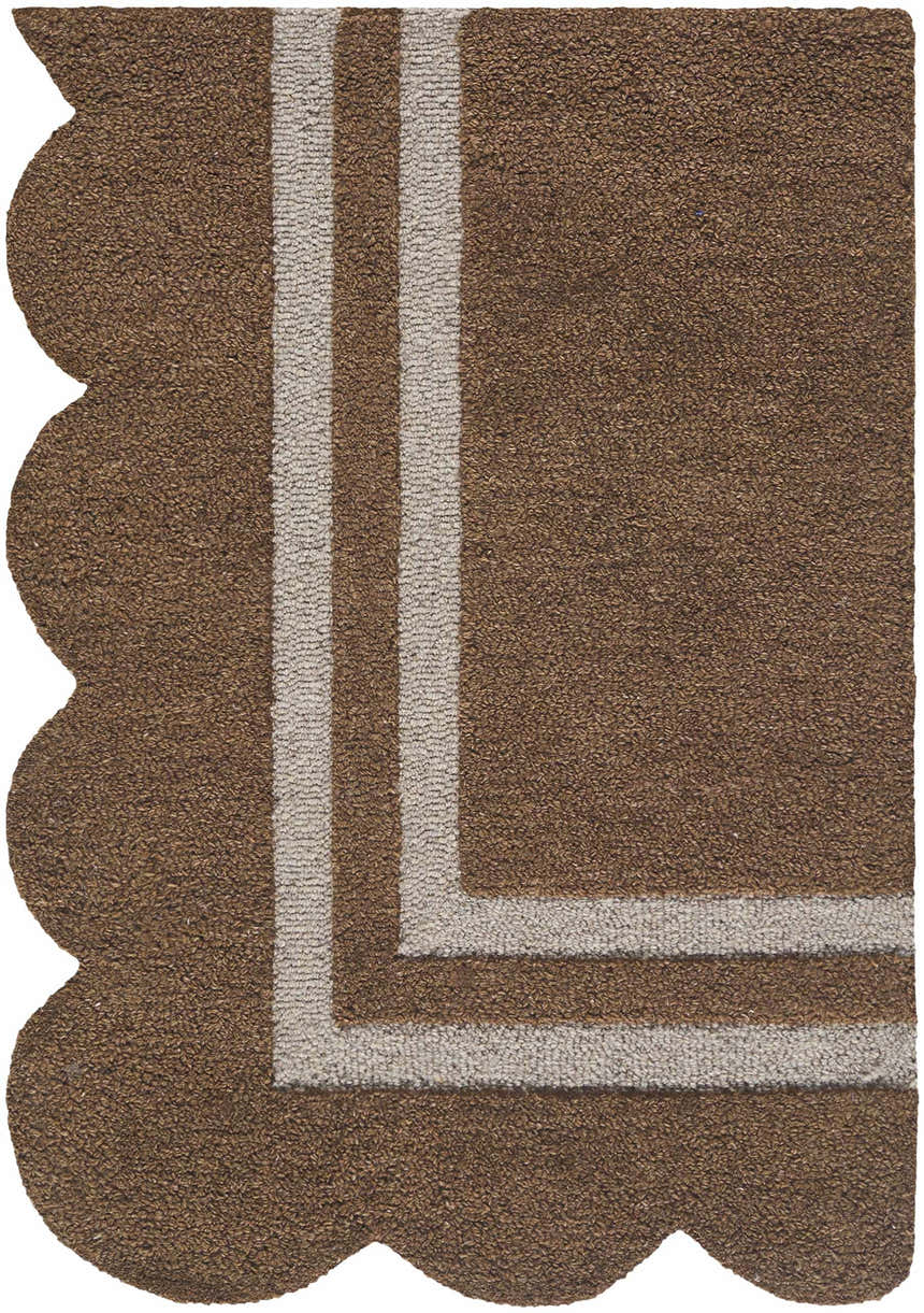 Close-up of the hand-tufted Chogan Umber Area Rug. Features a scalloped edge and umber and beige stripes. 100% wool texture. Corner