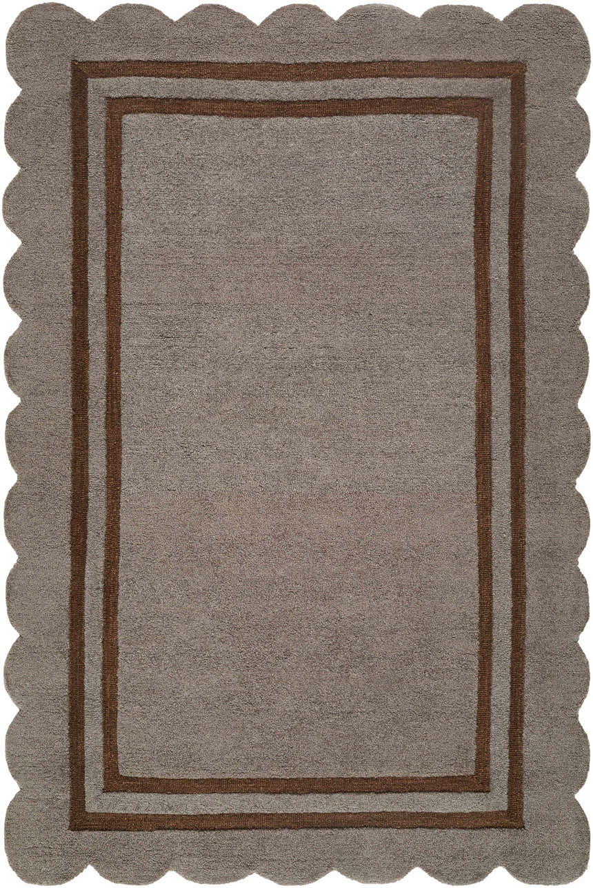 Close-up of the hand-tufted Chogan Charcoal Area Rug. Features a scalloped edge and brown border on a textured gray wool rug. Design-Rectangle-576