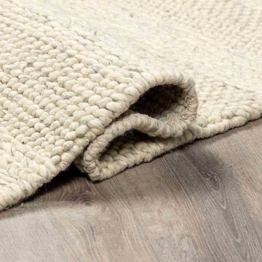 Close-up of the textured, hand-woven Clarke Textured Braided Stripe - Dark Beige Area Rug. Medium brown, 100% wool. Fold