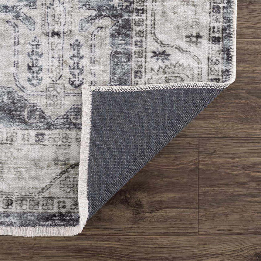 Close-up of the Off White Holi-4602 Washable Area Rug showing its traditional vintage pattern, fringed edge, and gray backing. Fold