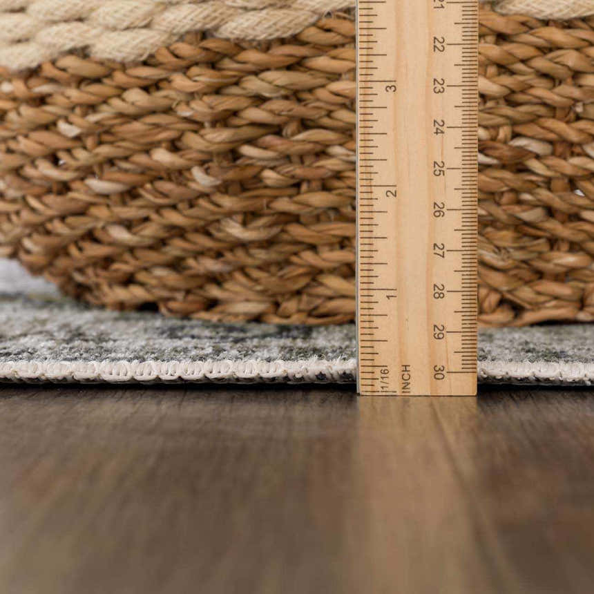 Close-up of the Off White Holi-4602 rug showing the pile height with a ruler and a basket for scale. Pile