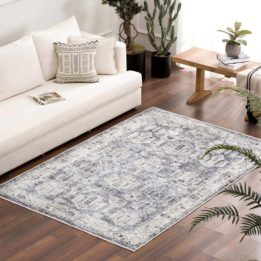 Living room scene with a white sofa and the Off White Holi-4602 washable area rug in beige, charcoal, and gray. Roomscene-Rectangle