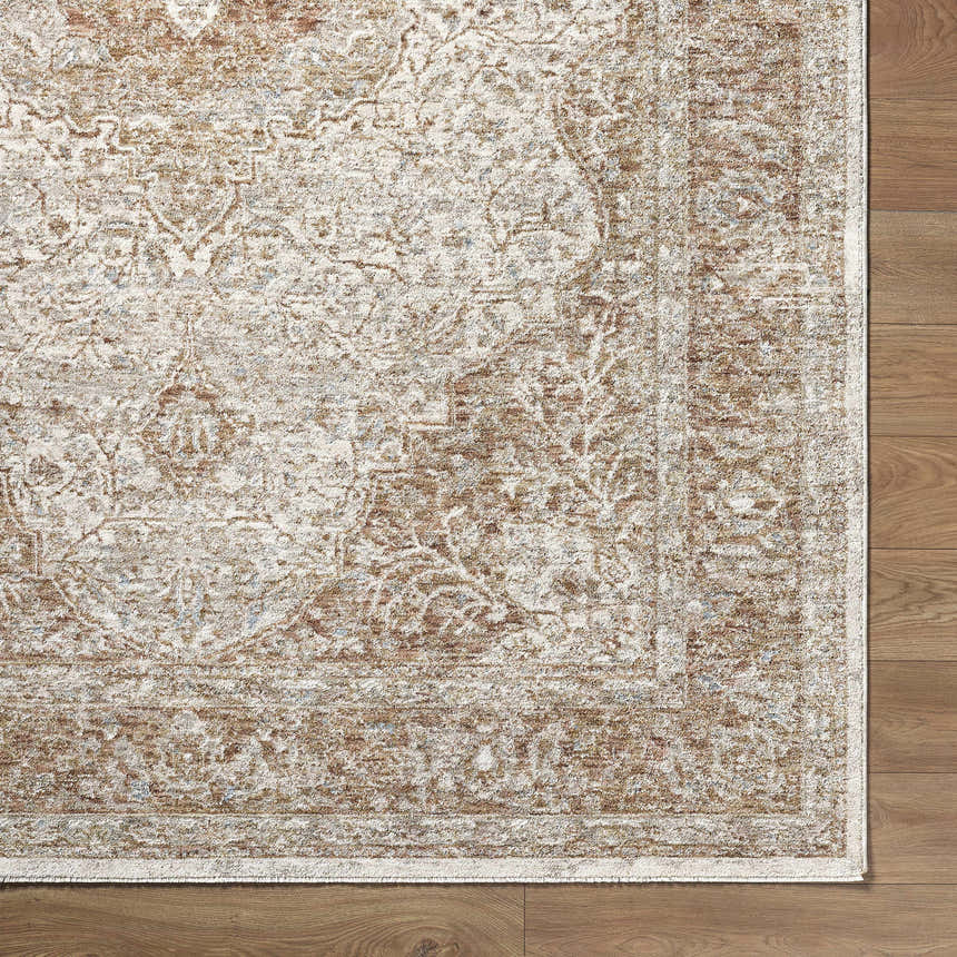 Close-up of Charae Ivory rug showing beige, sandstone, and taupe traditional pattern on wood floor. Corner