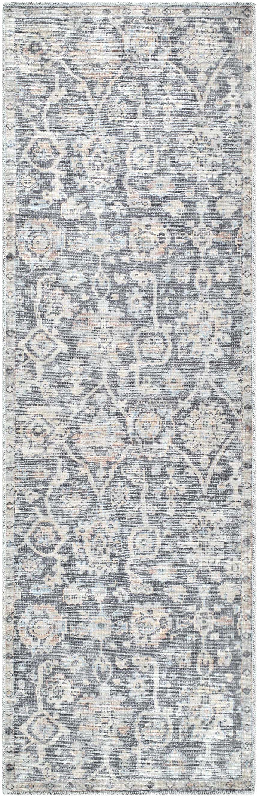Close-up of the Eleni rug. Machine woven rug in beige, black, burnt orange, denim, and gray with a traditional pattern. Design-Runner-27710