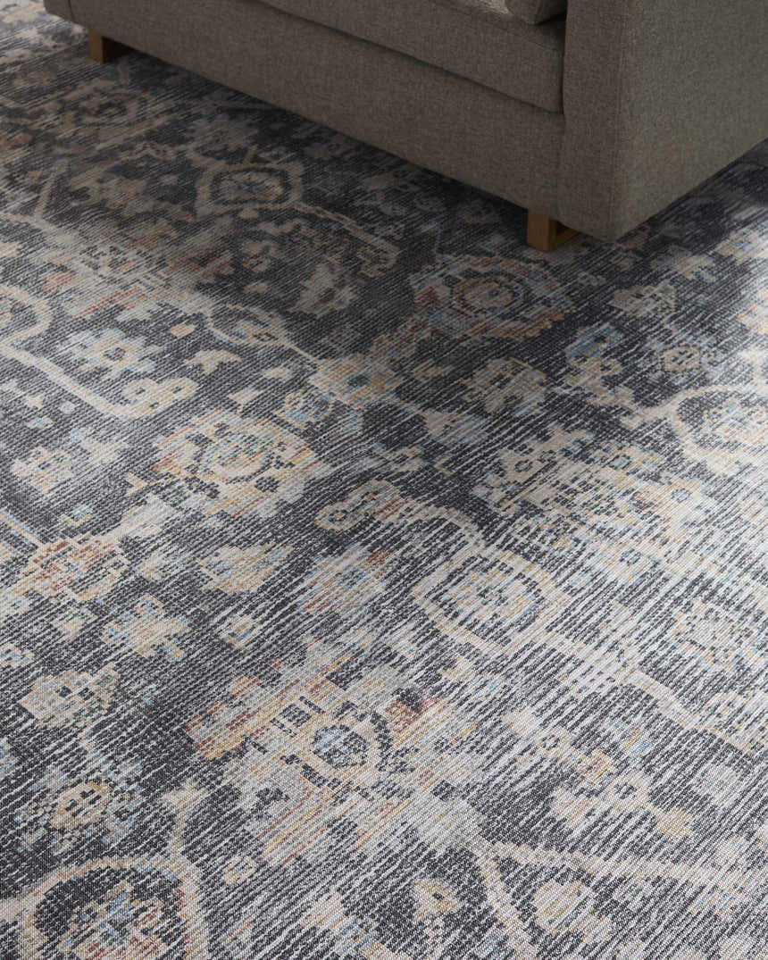 Close-up of the Eleni Vivir x LIVABLISS VVEL-2300 rug. Machine woven rug in beige, black, burnt orange, denim, and gray. Styleshot