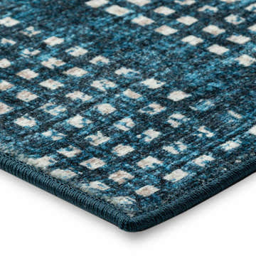 Close-up of the Delano DA1 Navy Area Rug, showing its navy, beige, and light blue geometric pattern and textured weave.