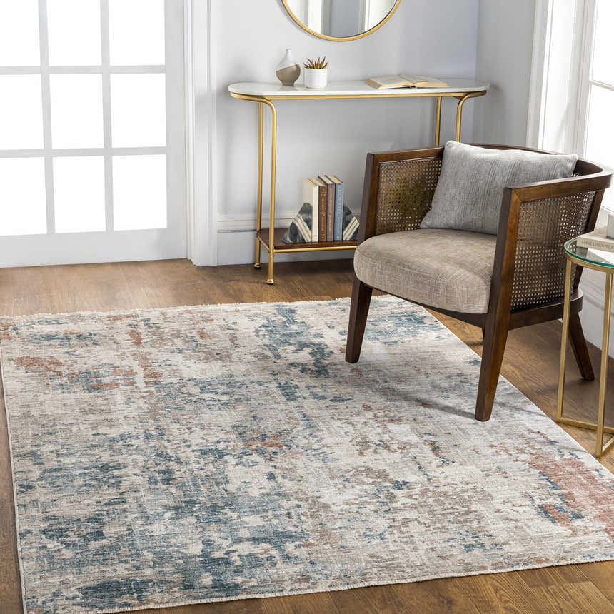 Living room scene with a contemporary Danlugan Area Rug in charcoal, cream, dusty pink, and blue. Modern, bright interior. Roomscene-Rectangle