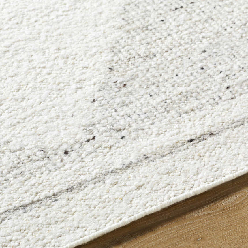 Close-up of the Ethara Ivory Charcoal rug showing its hand-woven texture and subtle global-inspired pattern. Texture