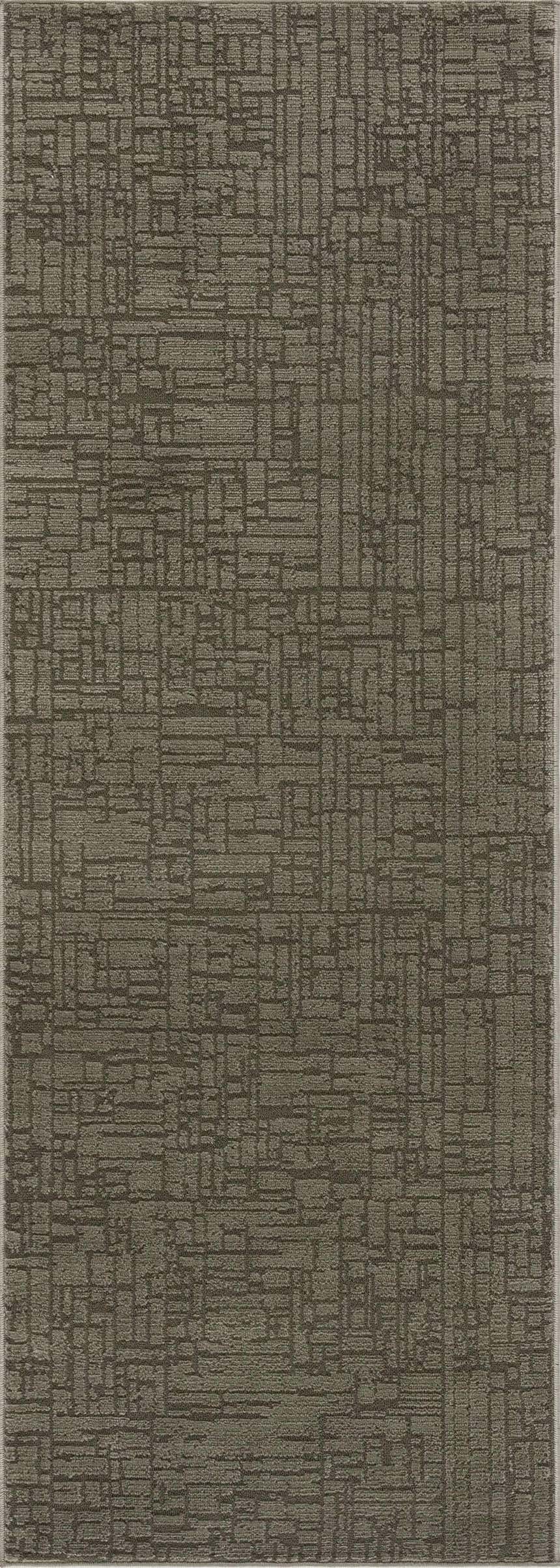 Close-up of the Leanna Green Washable Area Rug, showcasing its geometric pattern and textured gray-green color. Design-Runner