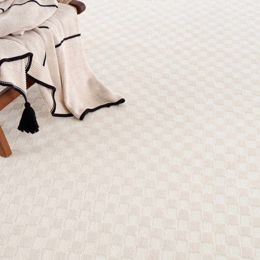 Close-up of the Gaiwan Cream Washable Area Rug, showcasing its subtle checkerboard pattern and soft, neutral tones. Styleshot
