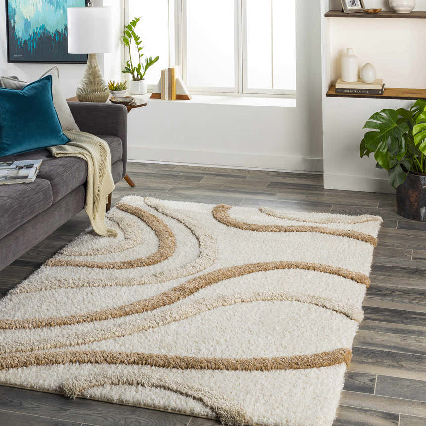 Living room scene with a gray sofa and the Espiye Area Rug, a shag rug with driftwood-colored wavy stripes. Roomscene-Rectangle