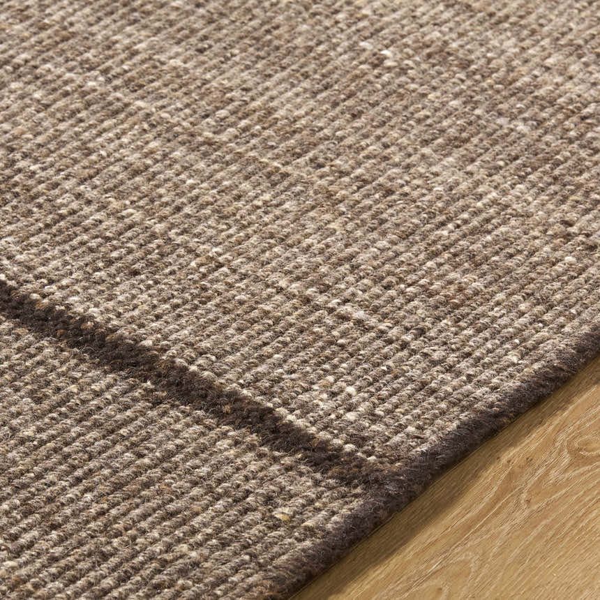 Close-up of the hand woven Lisua Global Modern wool rug, showing texture and neutral brown color. Texture