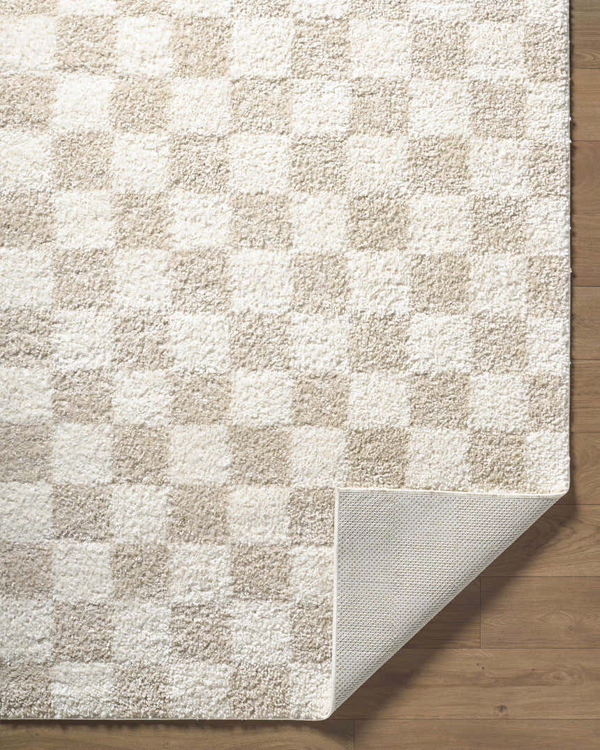 Close-up of the Gallicchio Area Rug, a machine-woven runner with a cream and beige checkerboard pattern and polypropylene material. Fold