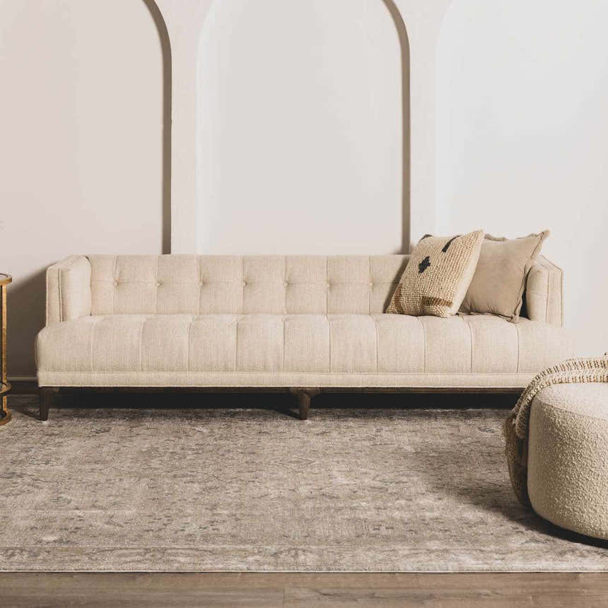 Living room scene with a beige sofa and Glengarry Thick Luxe Boutique Rug in dusty sage, light beige, and gray tones. Roomscene-Rectangle