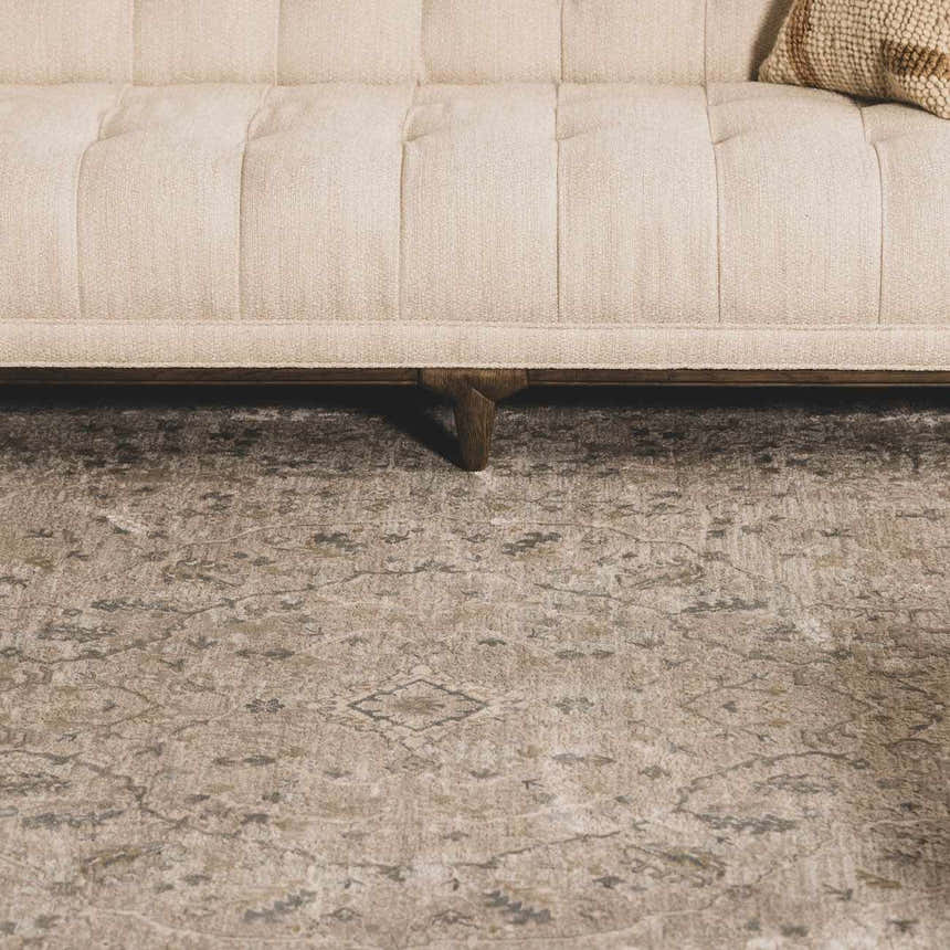 Close-up of the Glengarry Thick Luxe Boutique Rug in dusty sage, beige and gray under a sofa. Vintage style. Roomscene-Rectangle