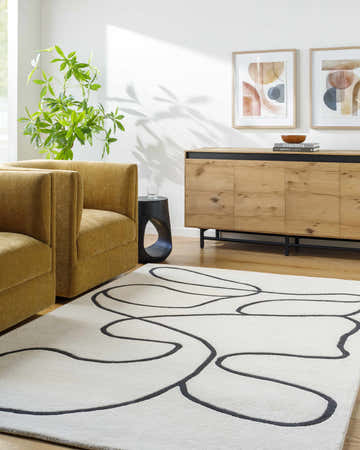 Living room scene with mustard chairs and the ivory Asasia Area Rug with charcoal abstract design. Roomscene-Rectangle