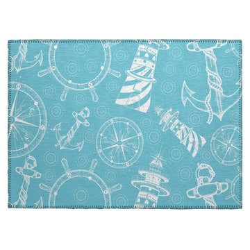 Close-up of Dalyn Harbor HA9 Ocean Washable Area Rug. Features a nautical pattern with anchors, lighthouses, and ship wheels.