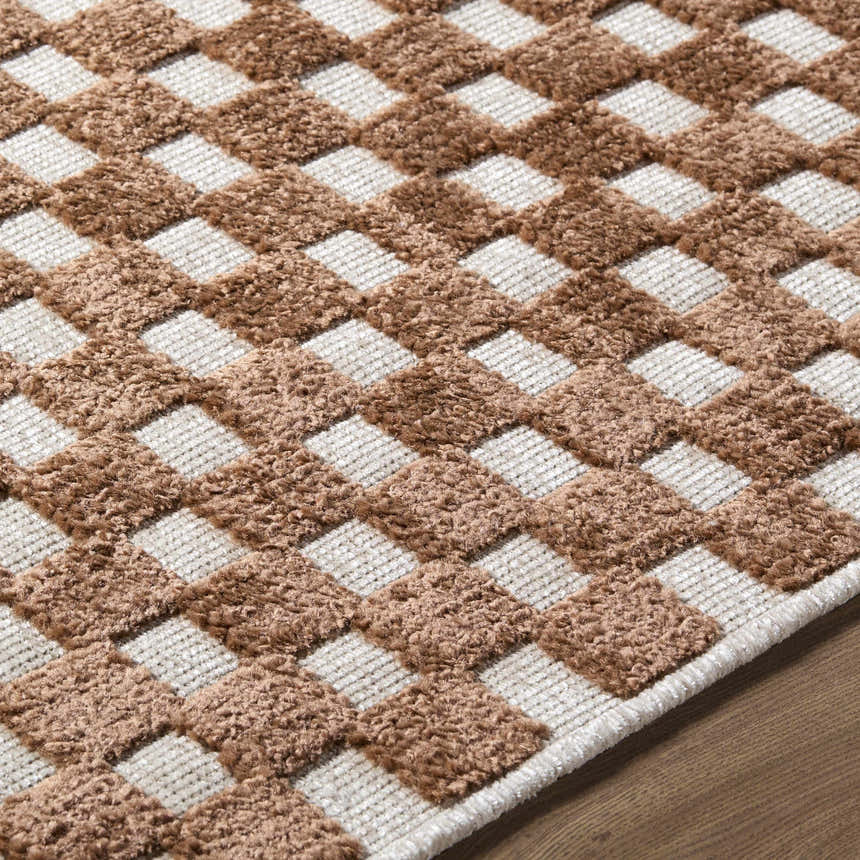 Close-up of the Anthea White Washable Area Rug. Brown and white checkerboard pattern with a soft, textured feel. Texture