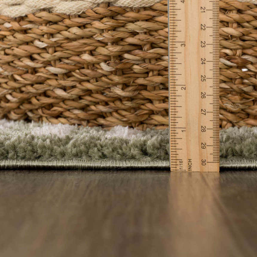 Close-up of the Allard Green Washable Area Rug showing its texture, pile height, and construction details. Pile
